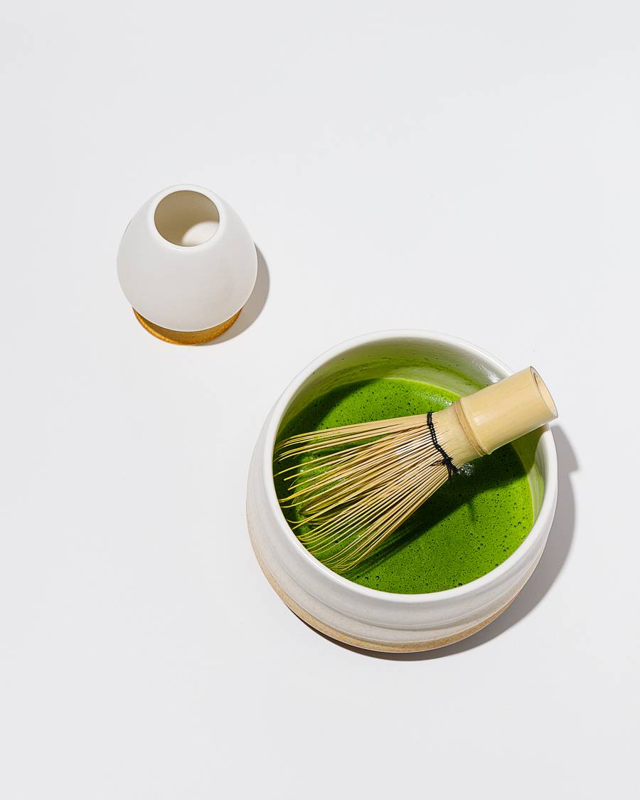 Whisking matcha in a ceramic bowl, traditional Japanese tea ceremony