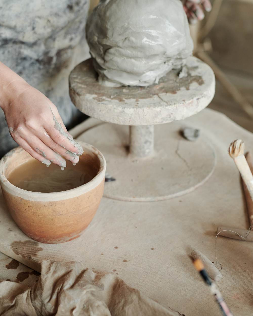 Shaping and finishing clay by hand at Craftorium