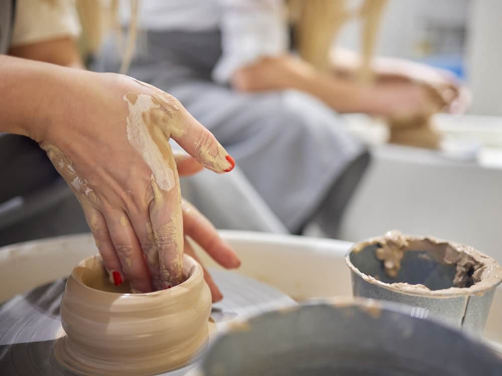 Guided one-on-one instruction at the pottery wheel
